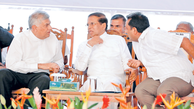 The ground breaking ceremony of the vehicle assembly plant of German automobile manufacturer Volkswagen Company was held in Kuliyapitiya yesterday under the patronage of President Maithripala Sirisena and Prime Minister Ranil Wickremesinghe. Picture shows President Sirisena in conversation with Prime Minister Wickremesinghe and Education Minister Akila Viraj Kariyawasam. Picture by Niroshan Batepola 