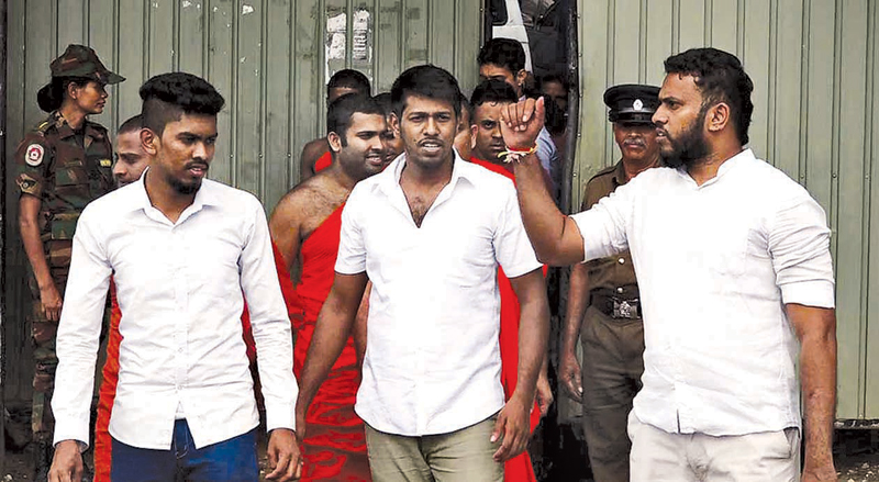 Amith Weerasinghe and the other two suspects leave the Kandy High Court on Monday. Picture by Asela Kuruluwansa