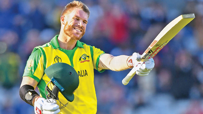 Australia’s David Warner celebrates after scoring a century (100 runs) during the 2019 Cricket World Cup group stage match between Australia and South Africa at Old Trafford in Manchester, northwest England, on July 6, 2019. AFP