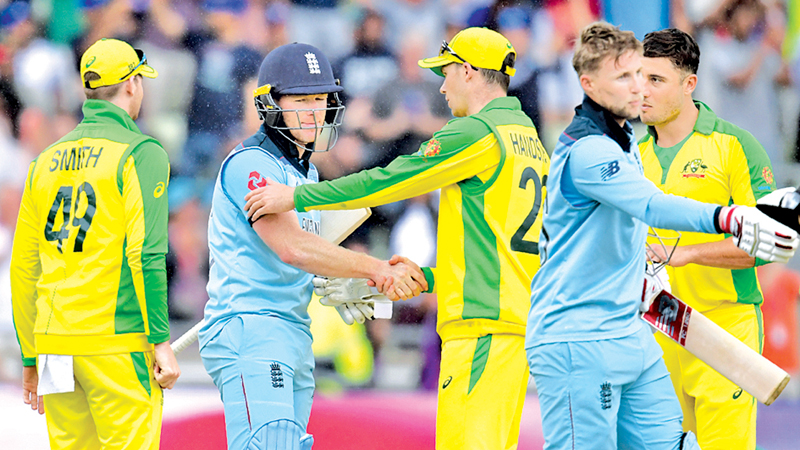 THE VICTOR AND THE VANQUISHED: England captain Eoin Morgan and Joe Root shake hands with the Australian players Steve Smith, Peter Handscomb and Marcus Stoinis after they had won the second World Cup semi-final by eight wickets at Edgbaston on Thursday. - AFP 