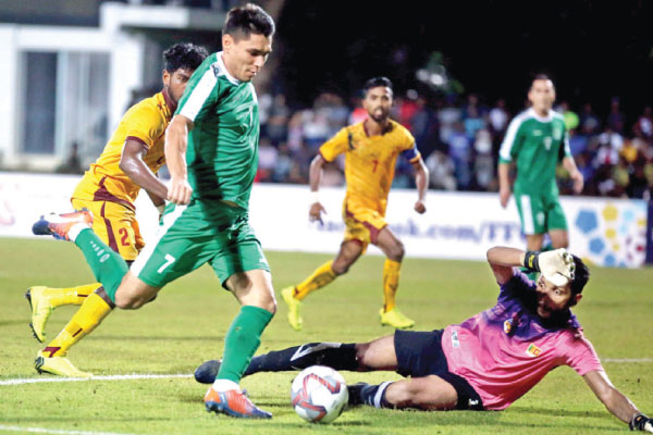 Turkmenistan’s Orazasahedov Vahyt scoring their opening goal in the World Cup qualifier against Sri Lanka at Racecourse grounds in Colombo yesterday. Picture by Sulochana Gamage