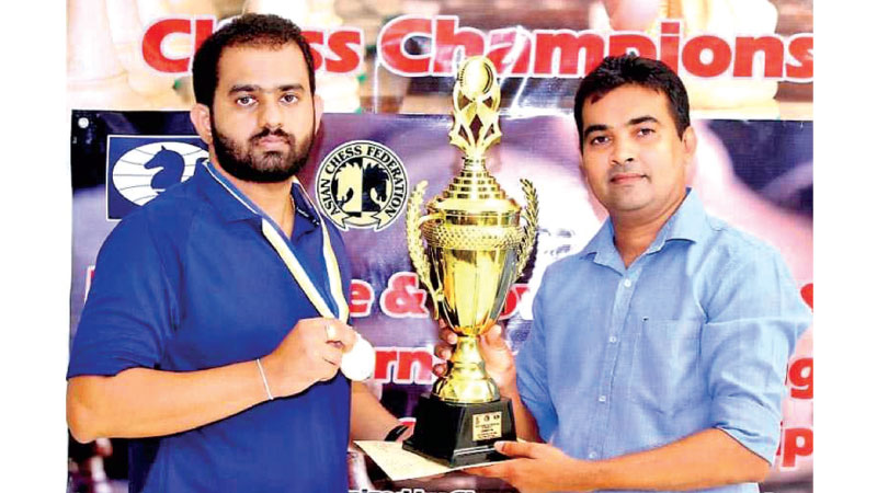 99X Technology Application Security Engineer Pranieth Chandrasekara receiving his trophy from Chess Federation of Sri Lanka Treasurer Irosh Jayasinghe at the 9th Mercantile-Government Service International Rating Chess Championship 2020