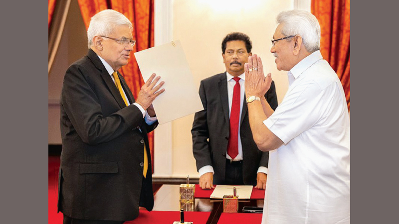 UNP Leader Ranil Wickremesinghe greeting President Gotabaya Rajapaksa after being sworn in as the Prime Minister yesterday. (Picture by PMD)