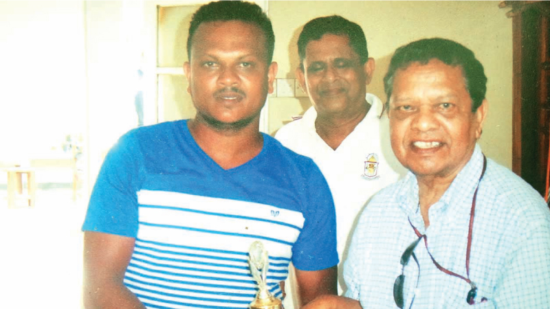 Walter Ranasinghe after presenting the Best Batsman award to the winner of Dept. of Education. Asst.Secretary, Padmasiri Manamperi is also in the picture. Pictures. by Upananda Jayasundera-Kandy Sports Spl. Corrs   