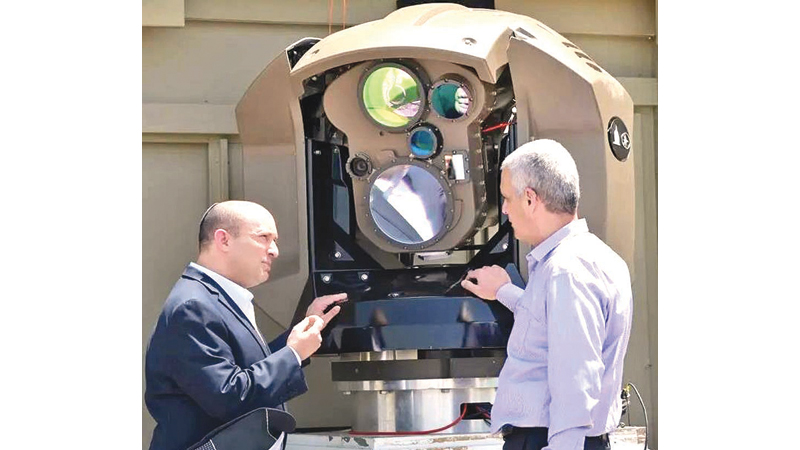 Israeli Prime Minister Naftali Bennett, (L), being shown a new laser-based air defence system at Rafael Advanced Defence Systems on Tuesday.