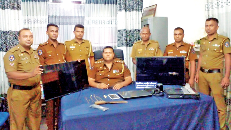 The Horana Police teams with the items that were stolen.  Picture by Priyadarshani Kahawala