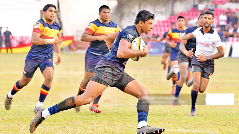 Thomian centre Ovin Hettiarachchi (with ball in hand) making a thundering run.     