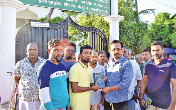 A copy of the Holy Quran in Sinhala was presented to former JVP Parliamentarian Sunil Handunnetti by youth activist J.R.A. Sajith, in Eravur yesterday.