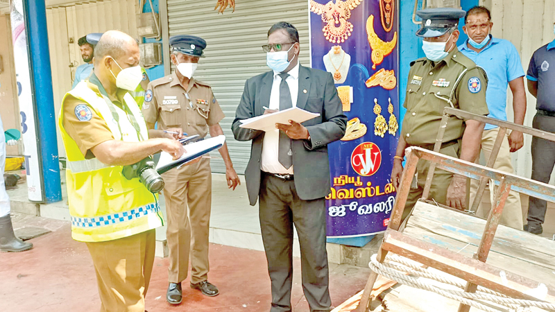 Magistrate T. Thiruvarul at the scene of the crime.