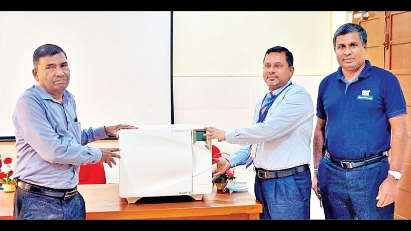 The presentation of the Autoclaves by Commercial Bank’s Regional Manager Northern, Ramachandran Sivagnanam and the Manager of the Point Pedro Branch of the Commercial Bank Thevaraajah Aravinthan to a representative of the hospital.