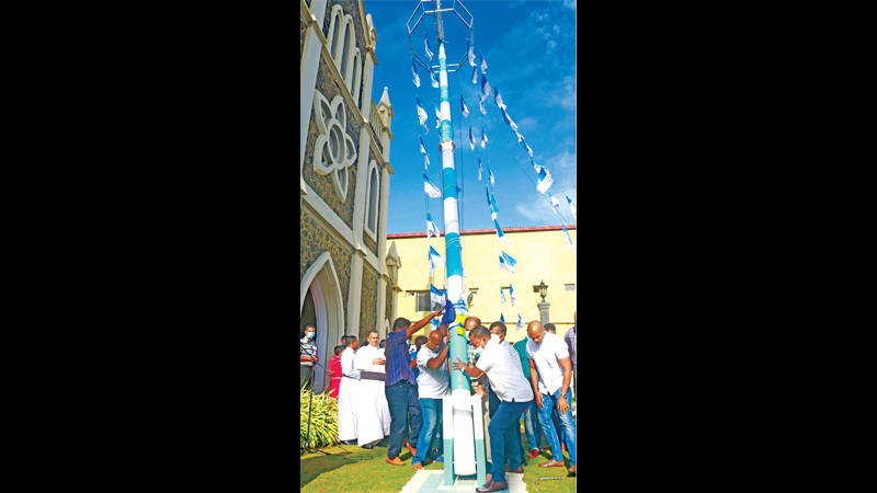 The flagstaff being hoisted at the National Shrine of Our Lady of Matara on Sunday.  Picture by Priyan de Silva