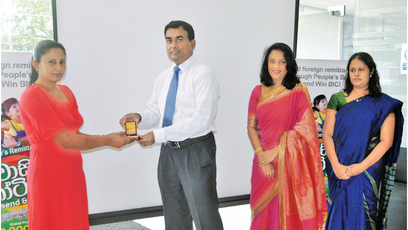 A winners receives her award from People’s Bank officials.