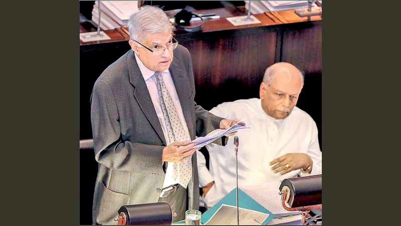 President Ranil Wickremesinghe addressing the Parliament. Prime Minister Dinesh Gunawardena looks on. 