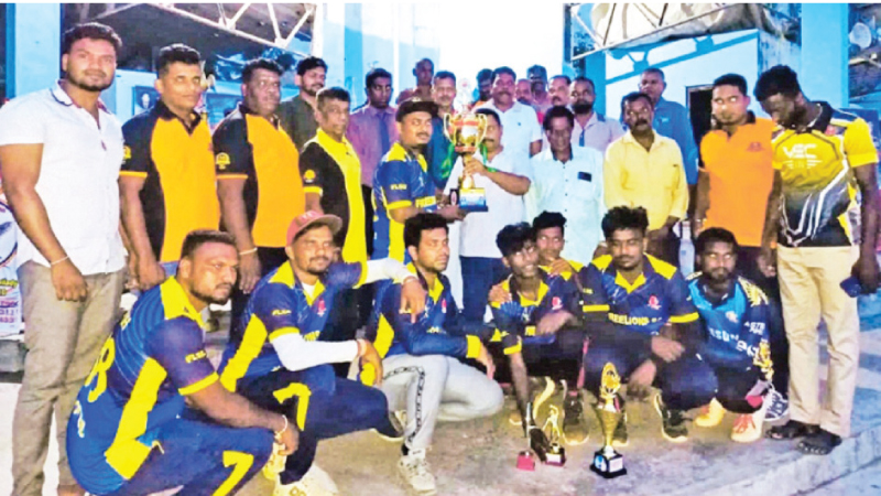 Champion Kaluthavalai Kenadi SC cricket team skipper receiving the trophy from the chief guest Dr. R.Muraleeswaran while the team members look on.