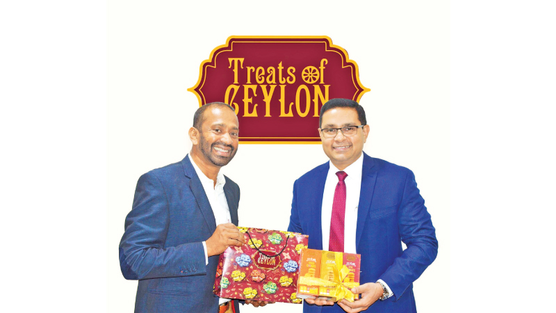 Dr. Lasantha Malavige, Chairman and MD of Lassana.com (Pvt) Ltd hands the first batch of ‘Treats of Ceylon’ cookies to Sanath Manathunge, MD and CEO of the Commercial Bank PLC recently.