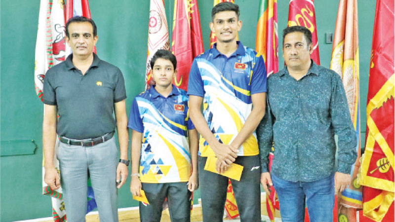 Most outstanding shuttlers Buwaneka Gunatilleka and Ranithma Gunatilleka poses for a picture with Sports Director S. Wijeratne (left) and senior coach and Sports Officer Kamal Gamlath. (Pic. courtesy Sports Ministry Media)