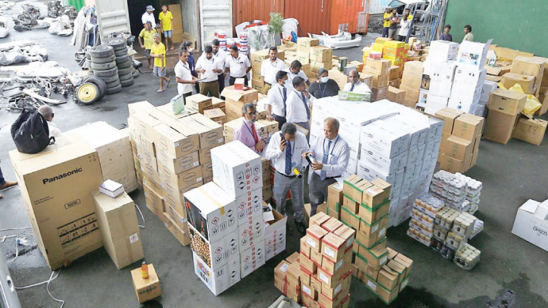 Customs officials at the Colombo Port after opening the container. Picture by Sulochana Gamage 