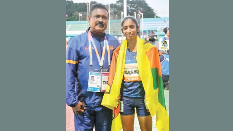 Tharushi Karunaratne and her coach Susantha Fernando after 800m event in South Korea. (pix courtesy Sri Lanka Athletics)