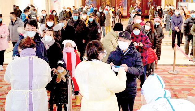 Residents line up to register for COVID-19 tests in Shijiazhuang in China’s Hebei Province.
