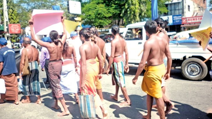 Adhivasi people taking part in the march  by Navaratna Bandara