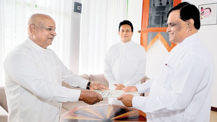 Susil Gunarathne swearing in as the Transport, Sports, Youth Affairs, Cooperative, Trade and Food and Industrial Development Minister of the NCP before Governor P.B. Dissanayake