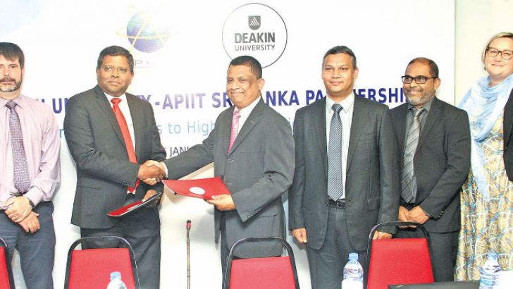 Officials of Deakin University, Australia and Asia Pacific Institute of Information Technology (APIIT) Sri Lanka exchanging the partnership agreement. Picture by Sulochana Gamage.