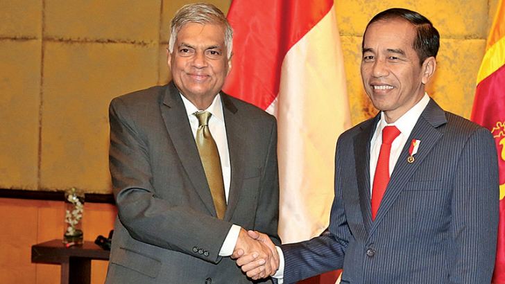 Prime Minister Ranil Wickremesinghe greets Indonesian President Joko Widodo at the Melina Hotel in Vietnam yesterday.  Picture by PM’s Media Unit.