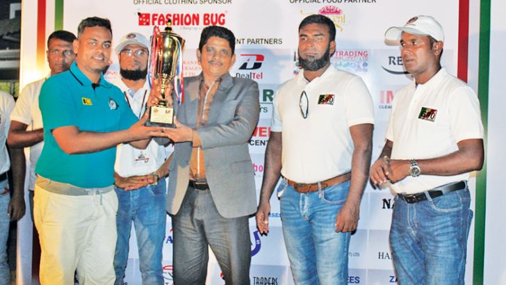 Soccer Tournament champions Zahira Veterans captain receiving  champion award from Bronze Sponsor  Genius  Engineering Services Pvt Ltd Senior Manager H.D.R. Janaka