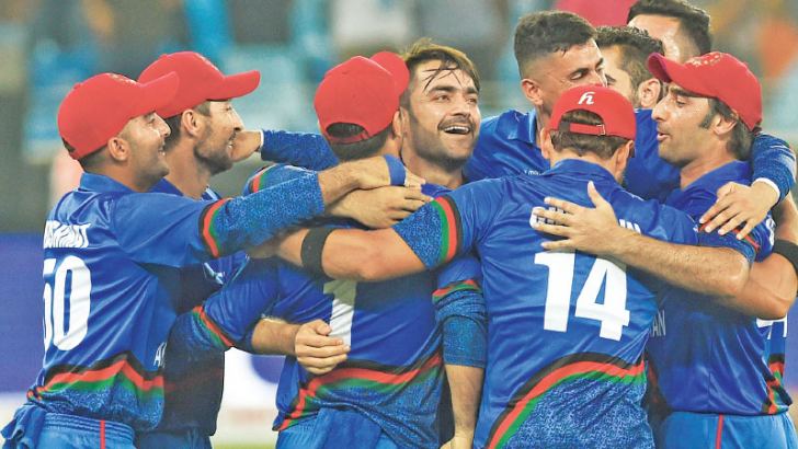 Afghan cricketer Rashid Khan (C), captain Asghar Afghan (R) celebrates with teammate after they tied their Asia Cup Super Four match against India at the Dubai International Cricket Stadium on Tuesday. AFP