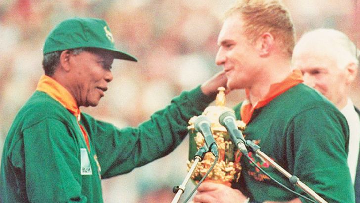 South Africa unites with 1995 Rugby World Cup win: SA captain Francois Pienaar congratulated by President Nelson Mandela.