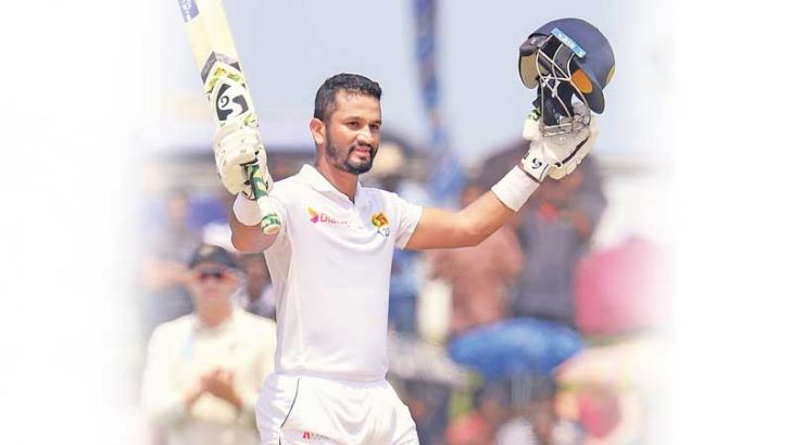 Sri Lanka captain Dimuth Karunaratne celebrates his century on the fifth and final day of the first cricket Test at the Galle International Stadium yesterday. – AFP