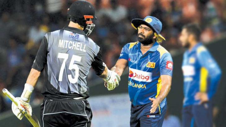 New Zealand’s Daryl Mitchell (L) is congratulated by Sri Lanka’s T20 cricket captain Lasith Malinga after victory in the first T20I at the Pallekele International Stadium on Sunday. – AFP