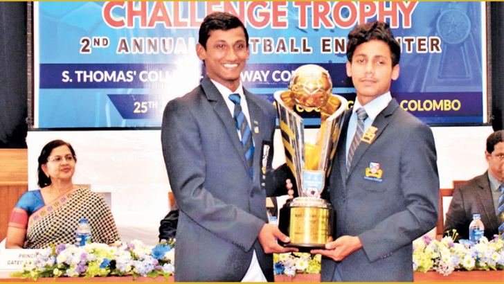 The Two Captains Shevan Ebenezer of S. Thomas' College, Mount Lavinia and Areeb Niyas of Gateway College poses with the 'Neville De Alwis - Ralph Alles' Challenge Trophy at the Press conference held at S. Thomas' College main auditorium on Thursday. Picture by Herbert Perera