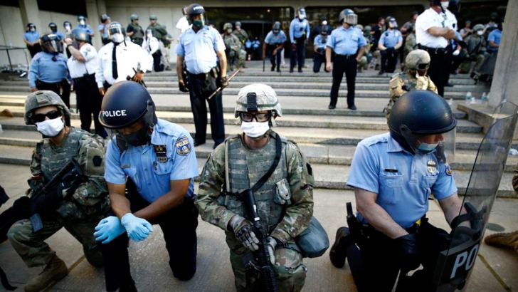 US Police officers taking a knee