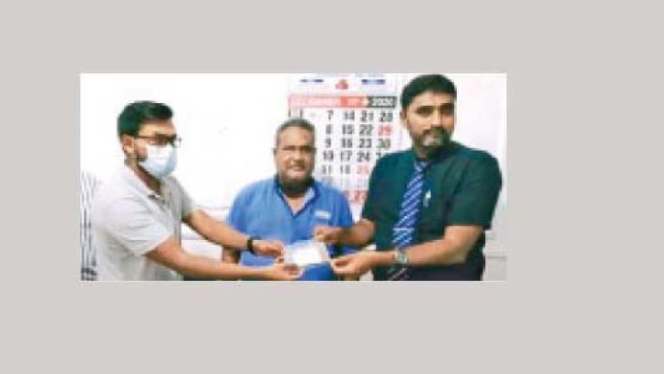Dr K.L.M. Nagfer with team hands over the Suwa Dharani to Teemah Biscuits Managing Director M.C.M. Zubair.