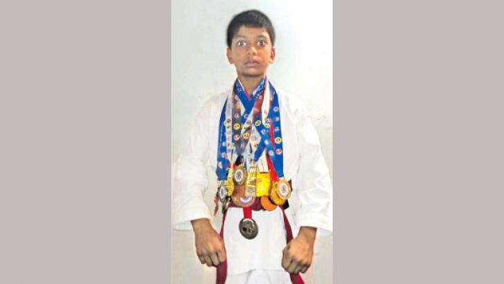 Chiran Lasitha is seen here with his medals