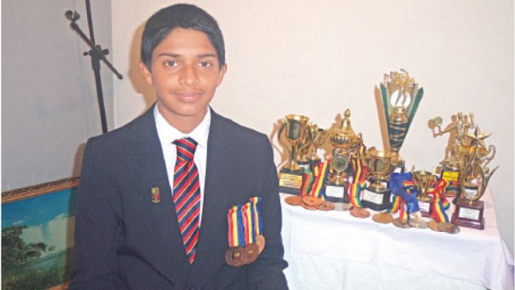 Sethmika Thinal Seneviratne - All-round Sportsman of Trinity College, Kandy with the trophies he has won.  (Picture by Upananda Jayasundera-Kandy Sports spl. Corrs.)