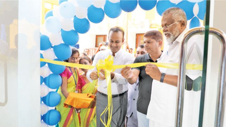 Plantations and Industries Minister Dr. Ramesh Pathirana opening the centre. Also pictured are Fisheries Minister Douglas Devananda, Plantation Industries State Minister Lohan Ratwatte.