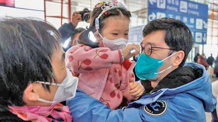 People embrace at the international arrivals gate at Beijing Capital International Airport after China lifted the COVID-19 quarantine requirement for inbound travellers.