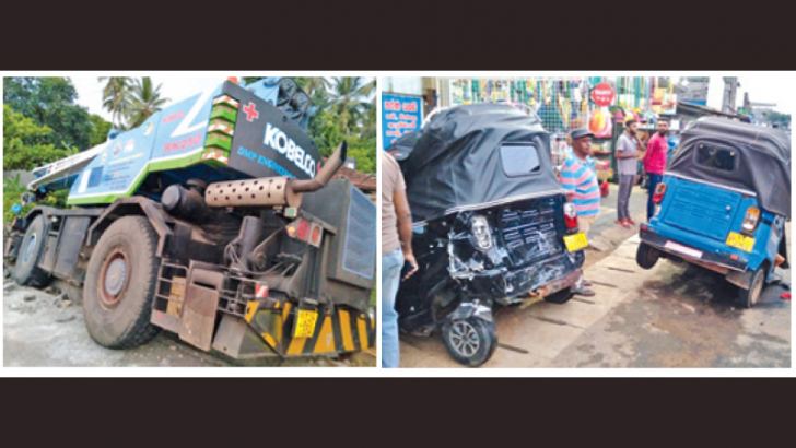 The crashed boom truck and some damaged three-wheelers.  Pictures by M. P. Kumara