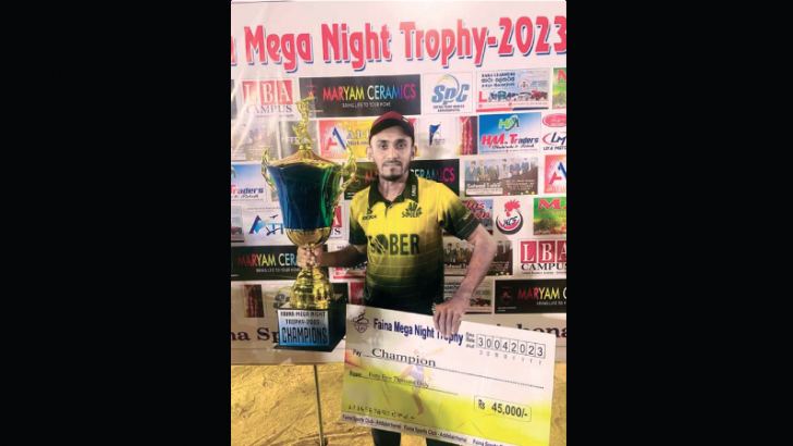 The skipper of  Addalaichenai Sober SC with the champion trophy and cheque