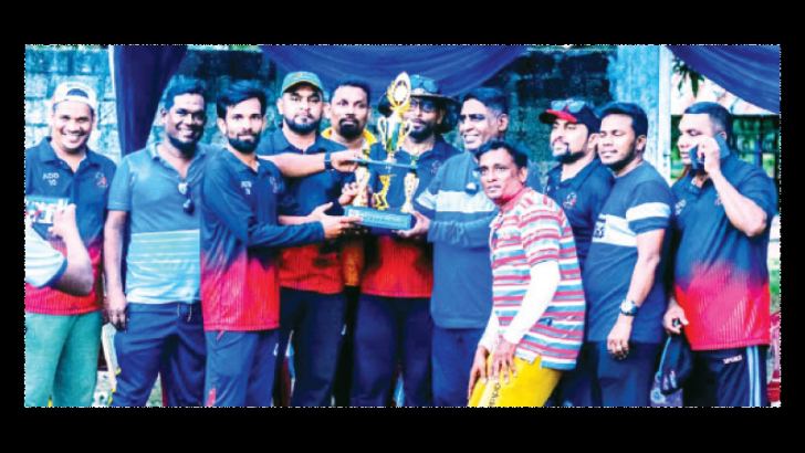 The Champion Addalaichenai Division -10 team with the trophy