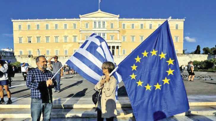 Protesters holding European Union and Greek flags near the Parliament in Athens, Greece.