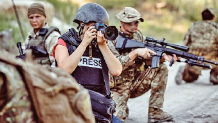A photo journalist in a war zone.